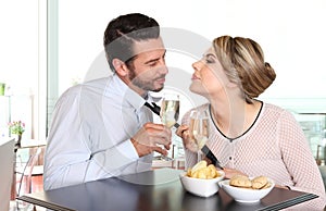 Woman pulling the tie to boyfriend, couple love concept