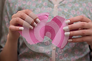 Woman pulling toilet paper tissue