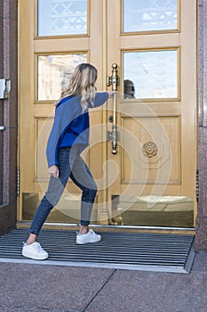 Woman pulls a closed door