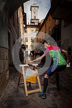 Woman punching at control point participating in orienteering competitions