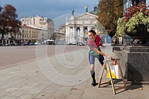 Woman punching at control point participating in orienteering competitions