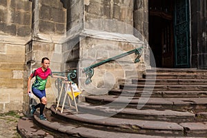 Woman punching at control point participating in orienteering competitions