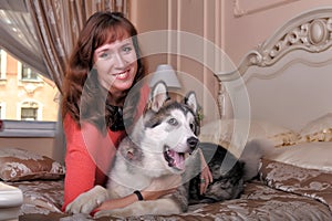 Woman with a puppy Malamute