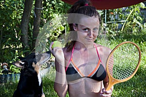 Woman with puppy. Summer holidays. sexy young tennis player relax with dog. its play time. be in playful mood. love to animals.
