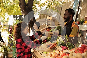 Woman purchasing farm fresh organic produce at farmers market