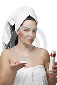 Woman with pure cotton cosmetic pads with cream