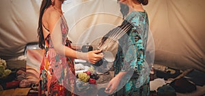 woman purifying the space with a ceremonial feather fan.