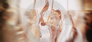 woman purifying the space with a ceremonial feather fan.