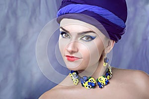 Woman in purple in jewelry of pansies