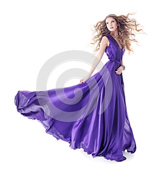 Woman in purple silk waving dress walking over white background