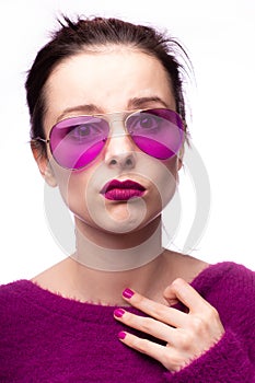 woman in purple sweater, purple glasses with purple lipstick on her lips