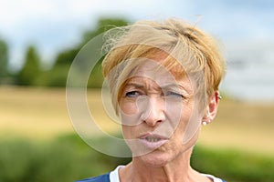 Woman pursing her lips as she looks aside