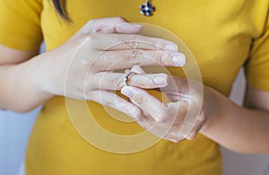 Woman push her silver wedding rings in finger