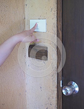 Woman pushing button door bell