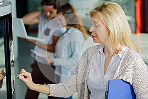 woman pushing button on vending machine