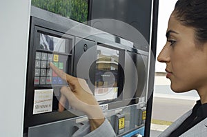 Woman Pushing Buttons On Fuel Pump