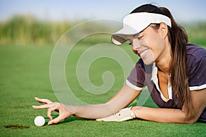Woman pushing golf ball