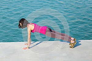 The woman is pushing up on the city promenade