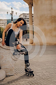 Woman put on rollers for roller-skating in the down town