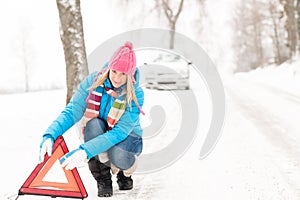 Woman put warning triangle car breakdown winter