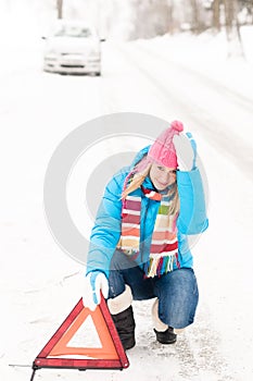 Woman put warning triangle car breakdown winter