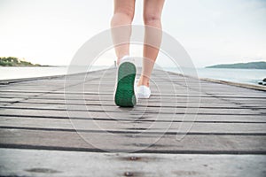 Woman put on white canvas shoes