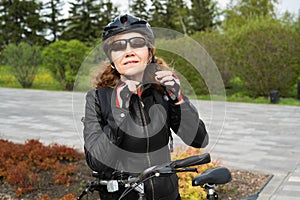 A woman puts on a bicycle helmet for cycling. Sports activities, women`s fitness