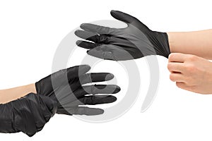 Woman puts on black rubber gloves