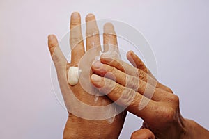 Woman puts cream on her hands