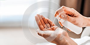 A woman puts on the hands of cosmetics from a bottle or liquid natural soap. Body care concept Banner