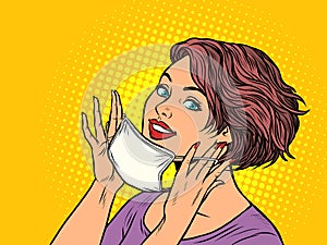 Woman puts on a medical mask