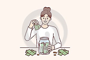 Woman puts money in jar wanting to save up to buy own house or start successful business