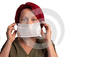 the woman puts on a protective medical mask. 