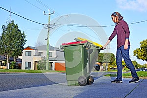 Woman puts recycling bins outside her home on waste collection day