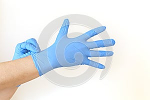 Woman puts on sterile medical gloves.