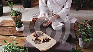 Woman putting chili pepper in organic handmade artisanal chocolate