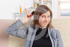 Woman putting on cochlear implant photo