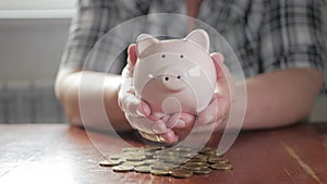Woman putting coin in piggy bank, saving money concept. Future needs loan education or mortgage credit spend vacation of
