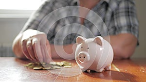 Woman putting coin in piggy bank, saving money concept. Future needs loan education or mortgage credit spend vacation of