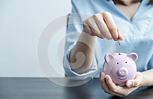 Woman putting coin into piggy bank, step up start up business to success, Saving money for future plan and retirement fund concept