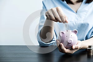Woman putting coin into piggy bank, step up start up business to success, Saving money for future plan and retirement fund concept