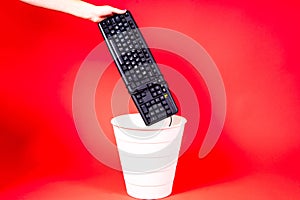Woman putting a computer keyboard in the e-waste trash bin, recycling concept