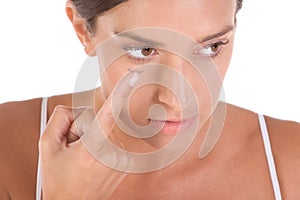 Woman putting on contact lens