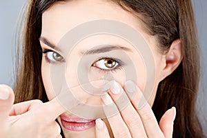 Woman putting contact lens