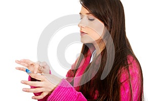 Woman putting contact lens in her eye.