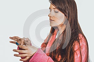 Woman putting contact lens in her eye.