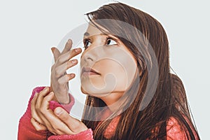 Woman putting contact lens in her eye.