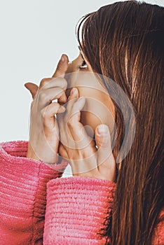 Woman putting contact lens in her eye.