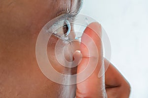 Woman putting on contact lenses the right way