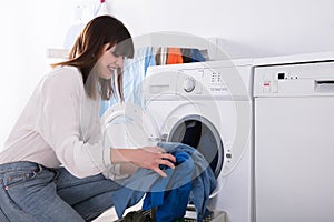 Woman Putting Dirty Cloth Into Washing Machine